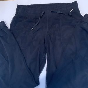 Black Lululemon joggers pants with mesh top layer
